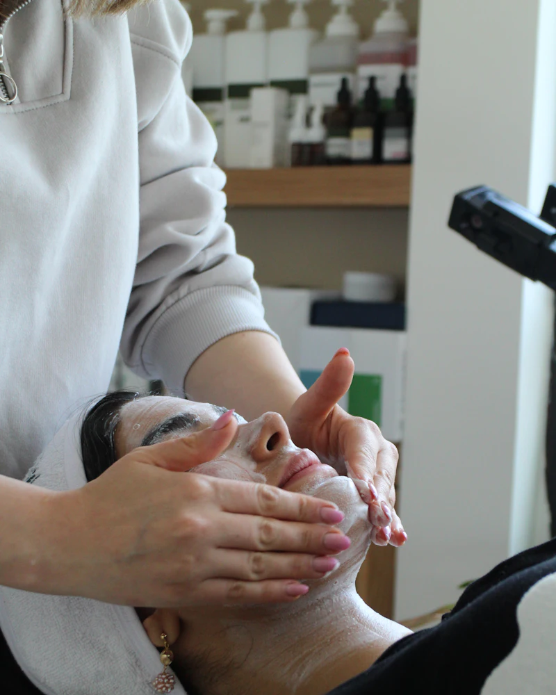 Hydrating face mask applied evenly by a Finenticee student, eye and lip area left clear